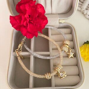 Duo of silver and gold bracelets, gold plated.